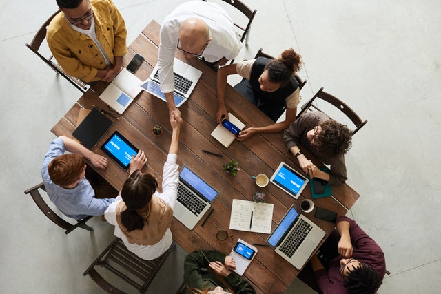 Team working together around a table.